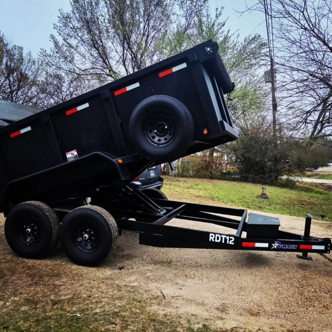 BlackIron Hauling 12-foot dump trailer tilted showing hydraulic lift system and dual axle