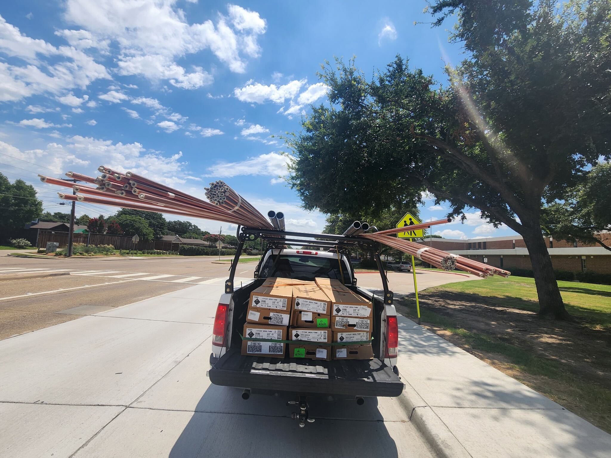 BlackIron Hauling delivering copper pipes and lumber to a residential job site in DFW