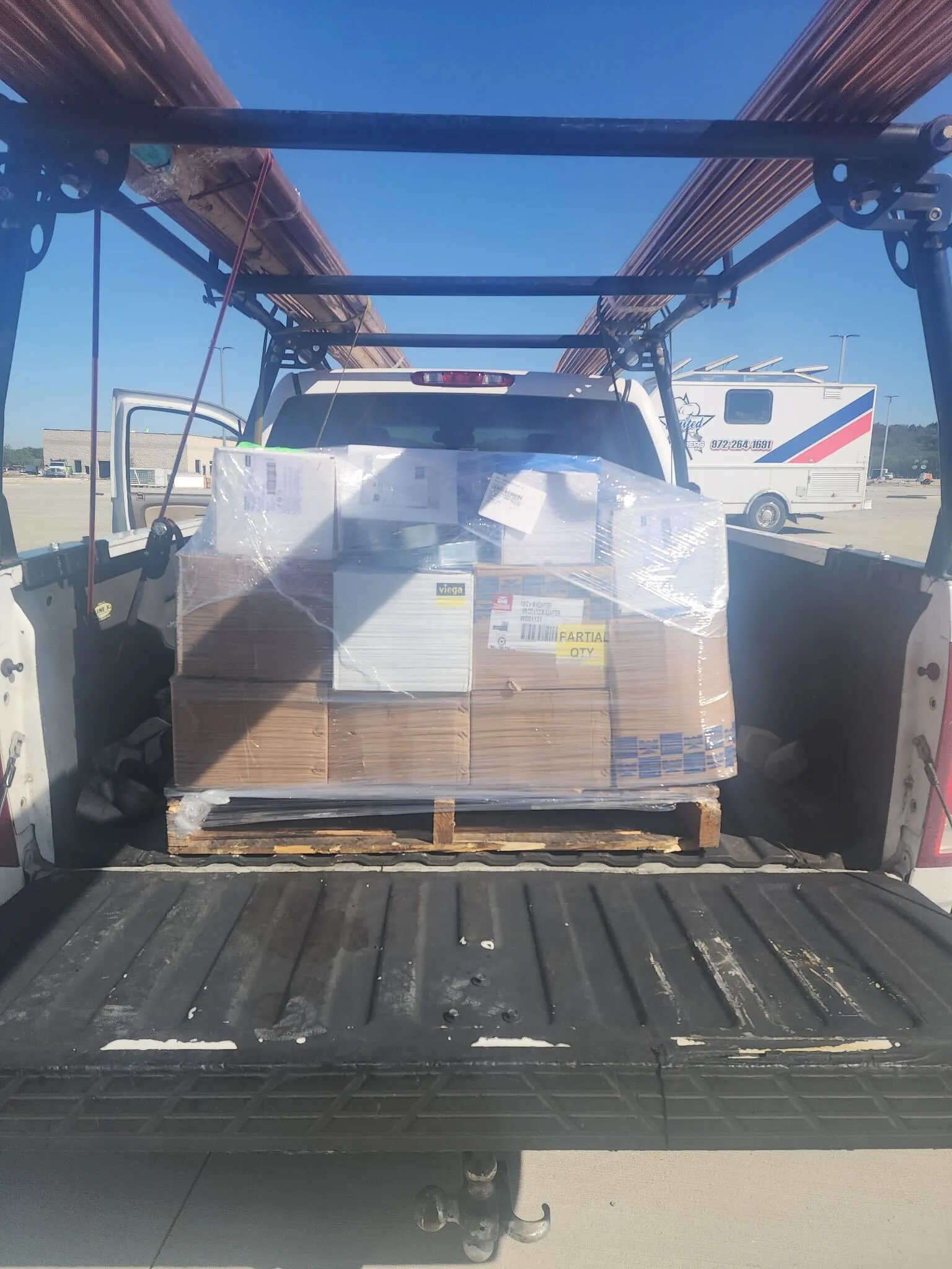 BlackIron Hauling truck with palletized cargo secured for delivery across Dallas-Fort Worth