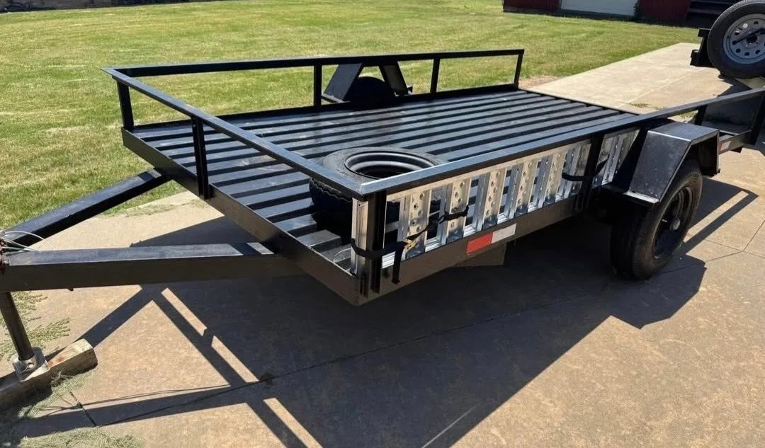 BlackIron Hauling 12-foot utility flatbed trailer front view with steel deck and railings